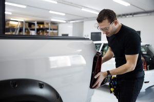 Medium shot man fixing car