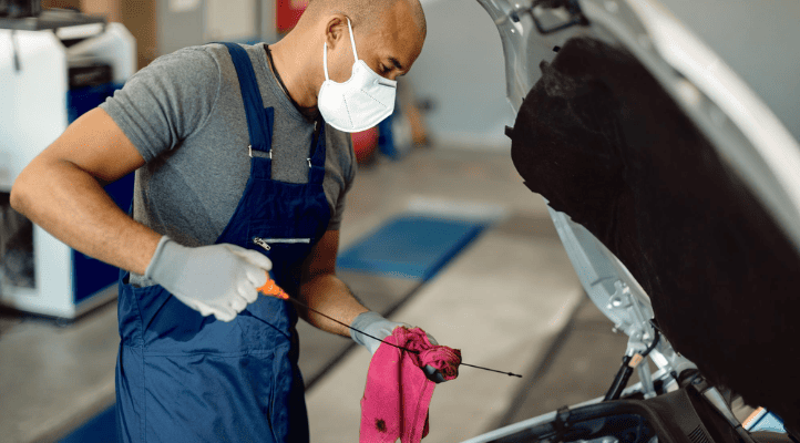 mechanic cleaning a car with preventative fuel system products