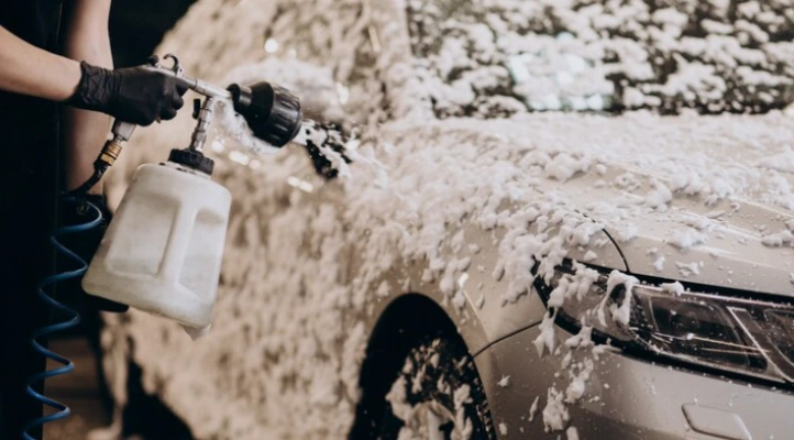 detailer applying thick wash foam to a vehicle